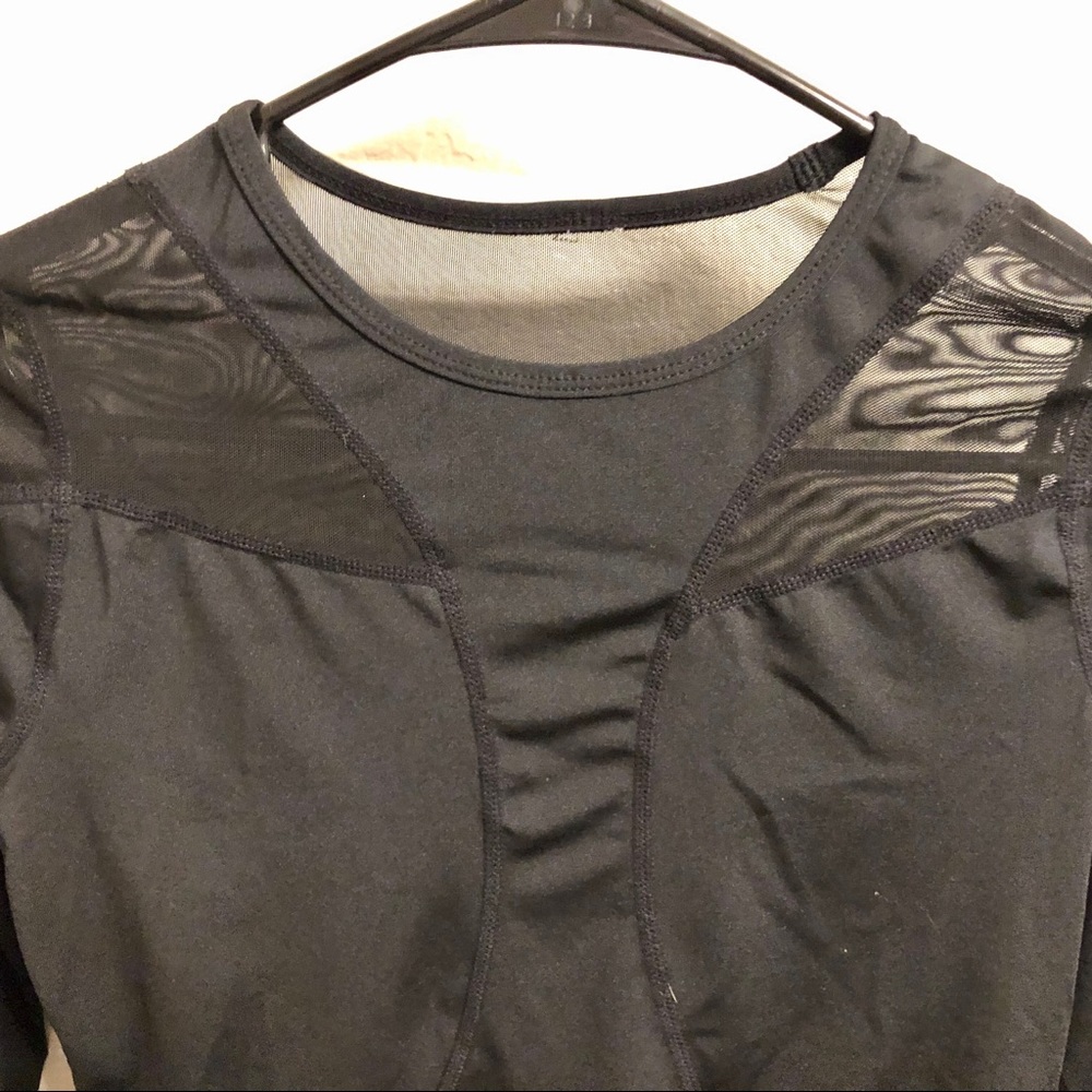 Black spandex workout top with mesh cutouts